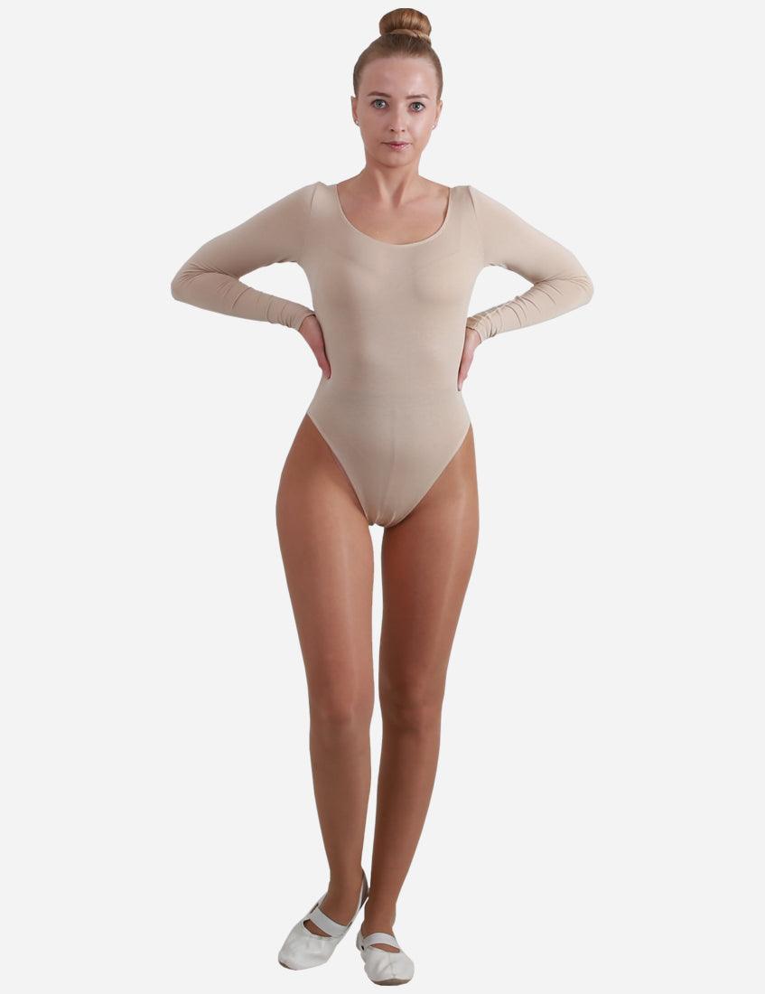 Professional adult ballerina posing confidently in a skin-toned long-sleeved leotard with a deep scoop neck.