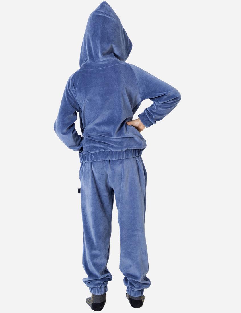 Back view of a young boy in a blue velvet tracksuit, highlighting the comfortable fit and casual style suitable for children's everyday wear.