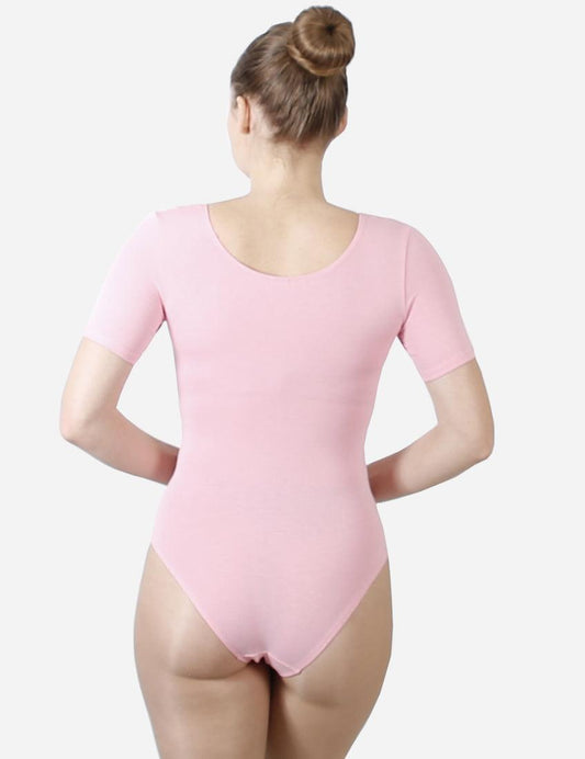 Back view of a ballet dancer in a pink short-sleeve leotard with a classic bun hairstyle