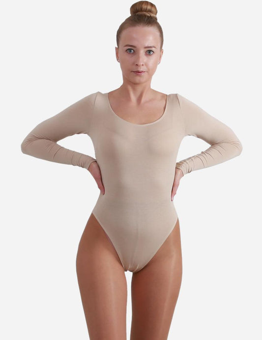Elegant adult ballet performer in a flesh-colored leotard with long sleeves and a scooped neckline, poised for dance.