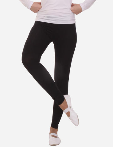 Model wearing black long leggings and white ballet flats, side view, on a white background.