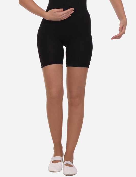 Black mid-length stretchy shorts for women, form-fitting and figure-flattering, displayed on a model from the front with white dance shoes.