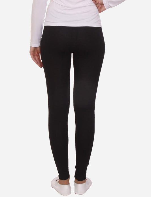 Casual black stretch leggings on a model, front view, paired with white ballet flats.