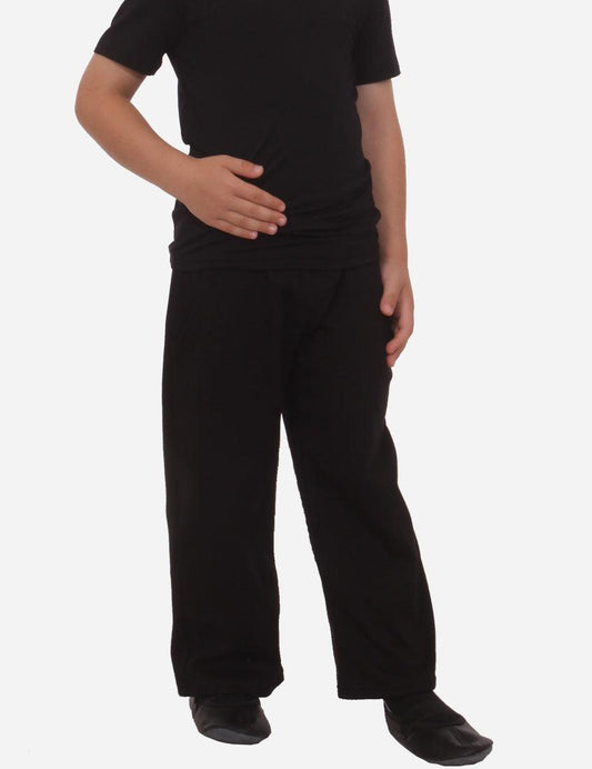Child in black t-shirt and straight-leg black pants partial side view on white background