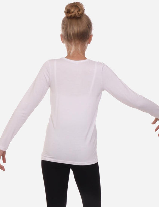 Back view of a young girl wearing a white long sleeve t-shirt and black shorts against a white backdrop