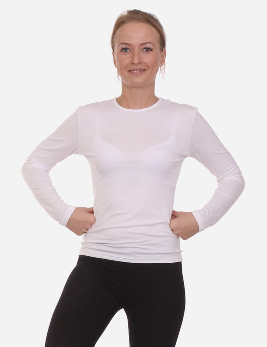 Smiling woman posing in a white long-sleeved shirt and black leggings, hands on hips, isolated on white