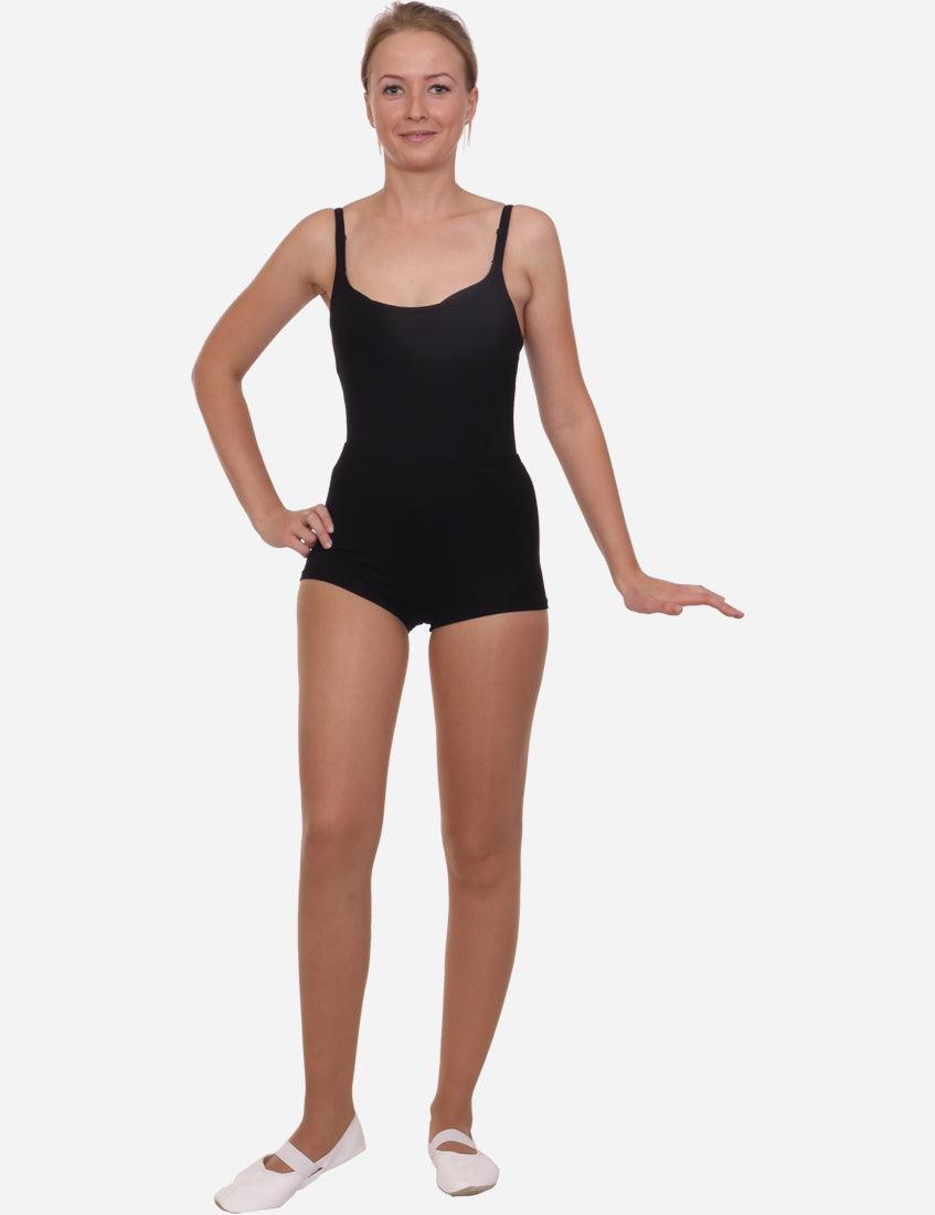 Side view of a woman modeling black short elastic shorts for sports and casual wear.