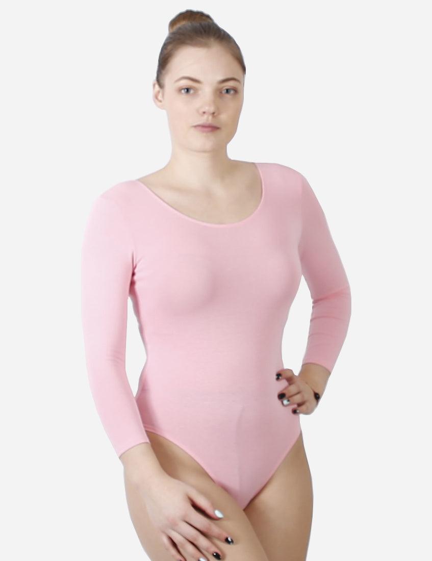 Young woman in pink ballet leotard with half-length sleeves, front view on white background